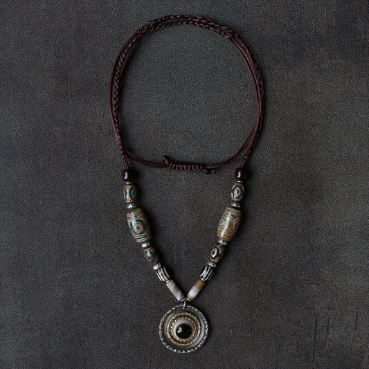 handcrafted Nepalese medicine eye Dzi bead necklace gray white front view