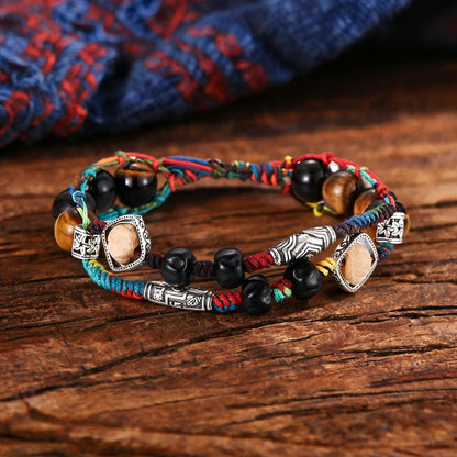 Hand-woven multicolor cord bracelet with engraved center spacer detail