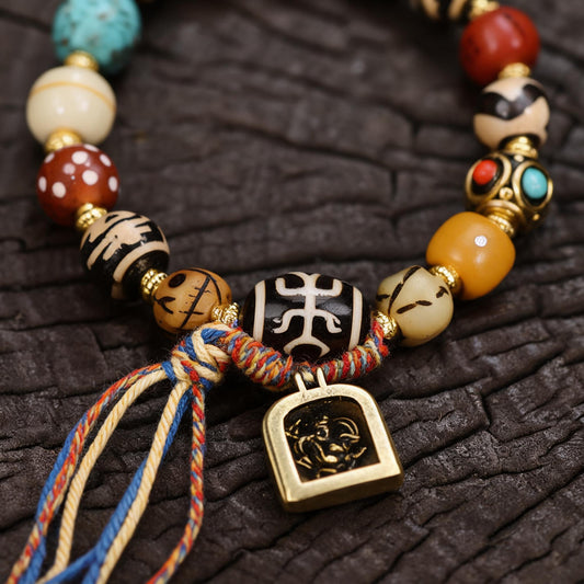 Tibetan bracelet dzi bead and gau box pendant detail