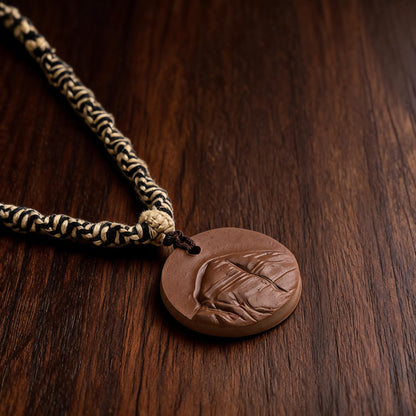 Close-up of black and cream braided cord and knot bead