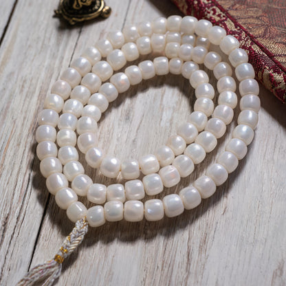 Handcrafted Mother-of-Pearl 108 & 27-Bead Mala Collection - Light of the Snowlands · 8×7 mm · 108 Beads · White-Gold Tassel - material and construction detail