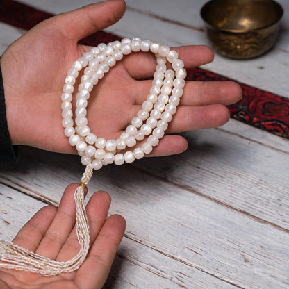 Handcrafted Mother-of-Pearl 108 & 27-Bead Mala Collection - Light of the Snowlands · 8×7 mm · 108 Beads · White-Gold Tassel - scale-use view