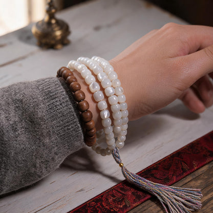 Handcrafted Mother-of-Pearl 108 & 27-Bead Mala Collection - Light of the Snowlands · 8×7 mm · 108 Beads · Multicolor-Gold Tassel - scale-use view