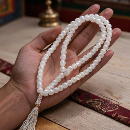Handcrafted Mother-of-Pearl 108 & 27-Bead Mala Collection - Tibetan Spirit · 7×6 mm · 108 Beads · White-Gold Tassel - scale-use view