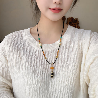 Kumbu dzi bead amber necklace model wearing