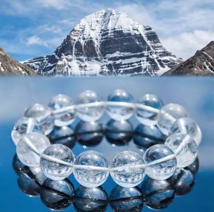 Clear quartz bead bracelet with a snow-covered mountain backdrop