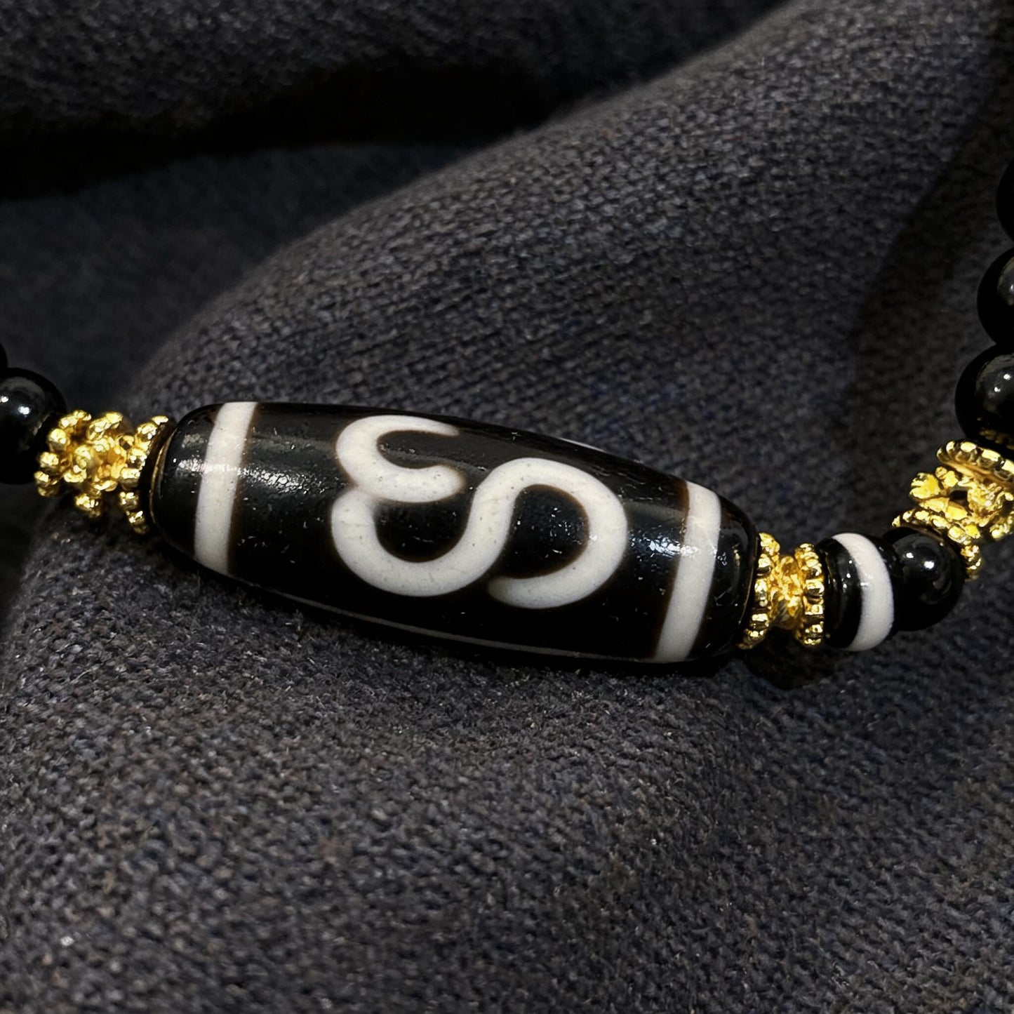 Design O dzi bead pendant detail close-up