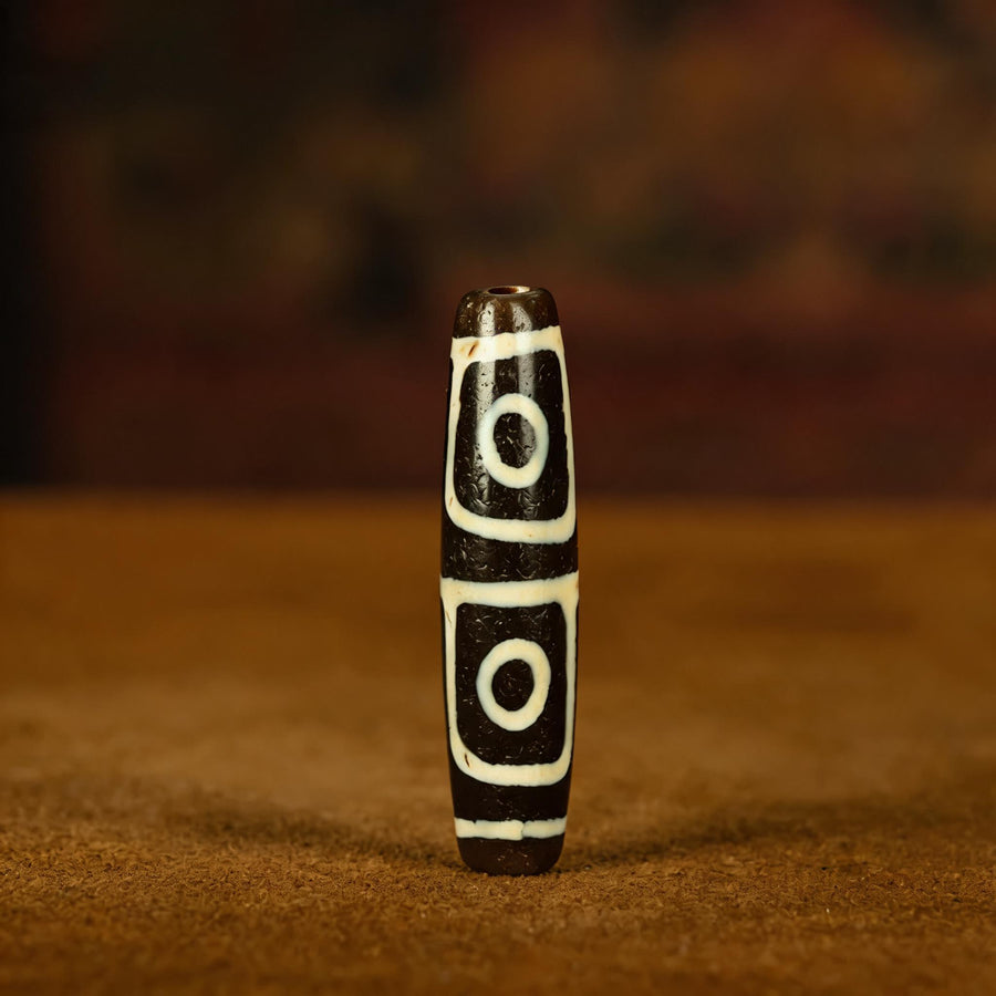 Millennium pure black and white four-eye Dzi bead collector documentation view 1