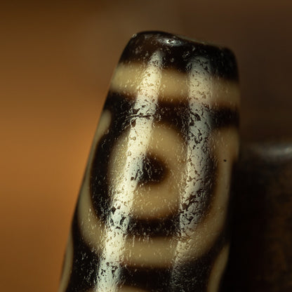 Tibetan dzi bead six eye motif close up