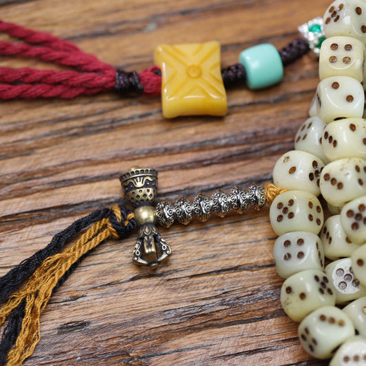 Carved yak bone dice mala side view