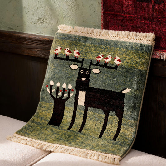 Sage Green Deer Motif Mini Tibetan Rug three-quarter view