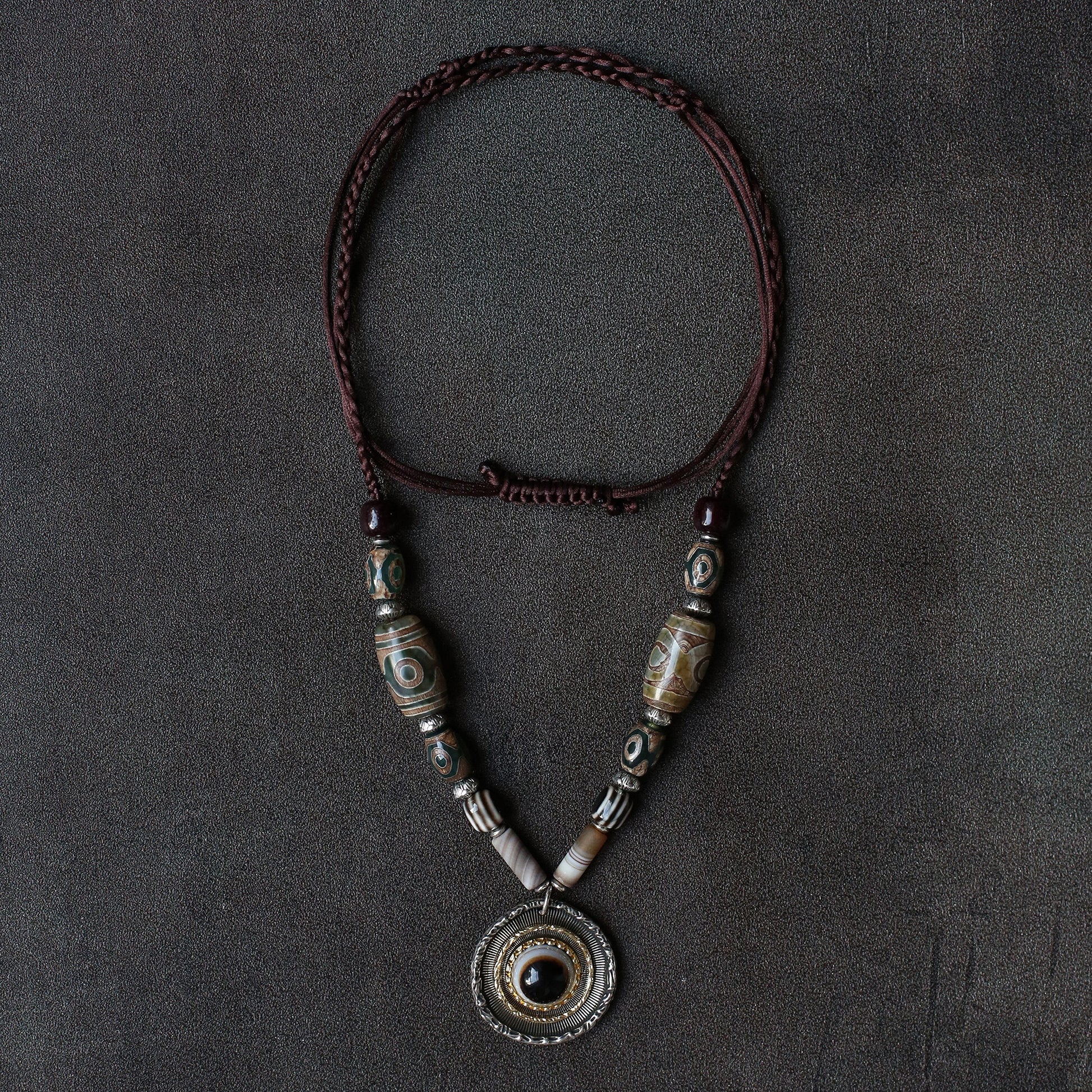 handcrafted Nepalese medicine eye Dzi bead necklace gray white front view