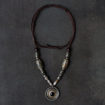 handcrafted Nepalese medicine eye Dzi bead necklace gray white front view