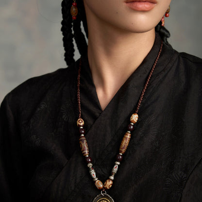 handcrafted Nepalese medicine eye Dzi bead necklace gray white proportional wearing view