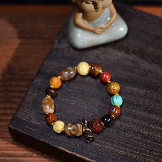 Handcrafted Bone Dzi-Style Mixed-Bead Bracelet - complete bracelet on a wooden display