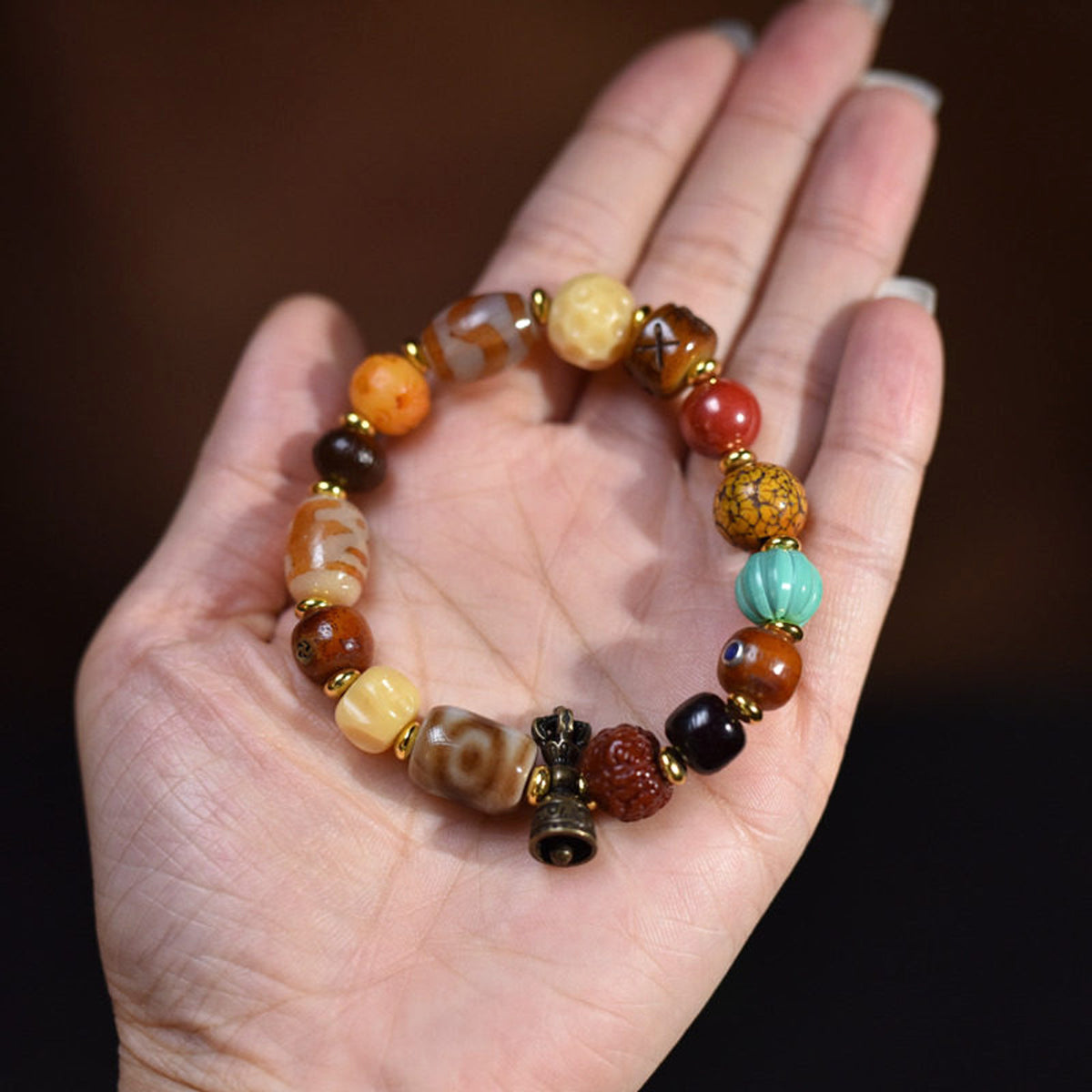 Handcrafted Bone Dzi-Style Mixed-Bead Bracelet - hand scale