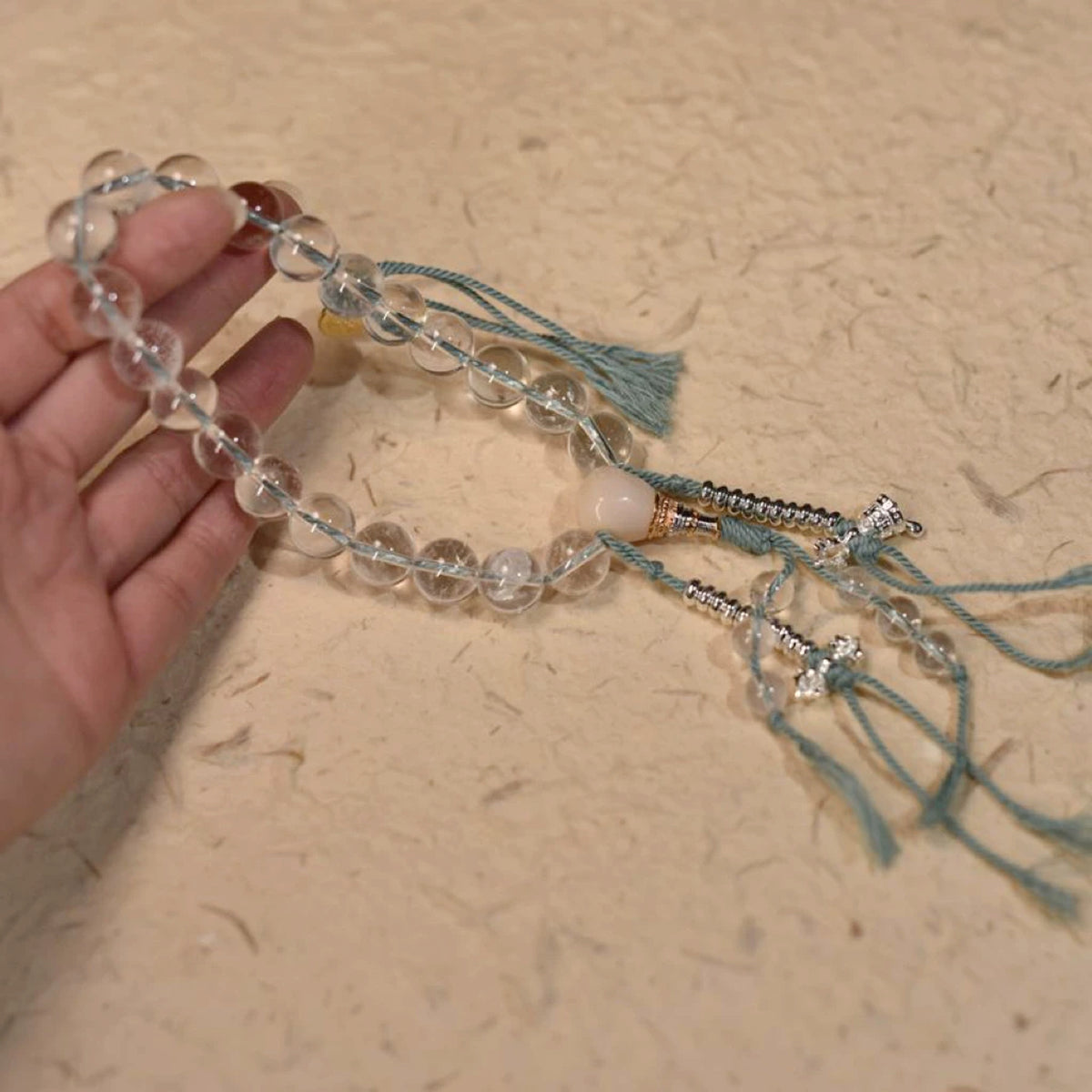 Handcrafted Himalayan Clear Quartz 21-Bead Mala - hand scale