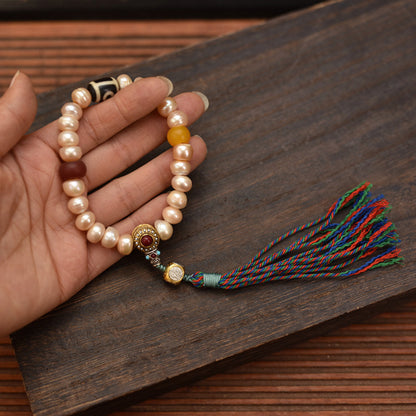 Handcrafted Champagne Pearl Bracelet with Tassel - hand scale