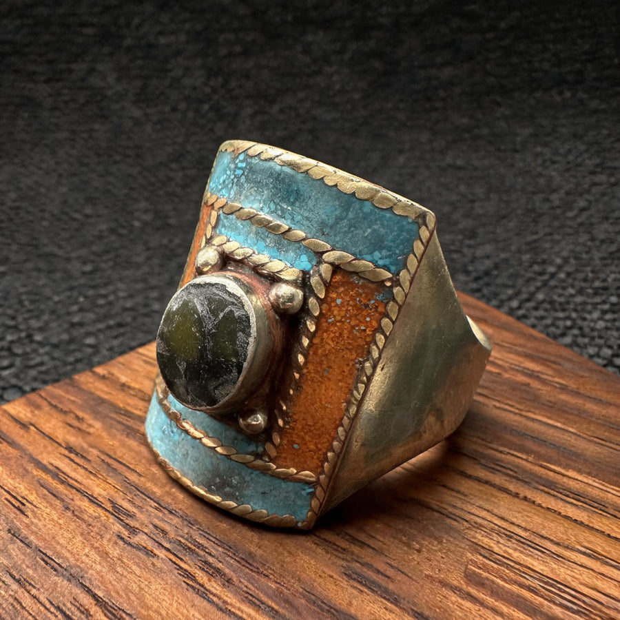 Hand-inlaid turquoise orange and dark stone statement ring front three-quarter view