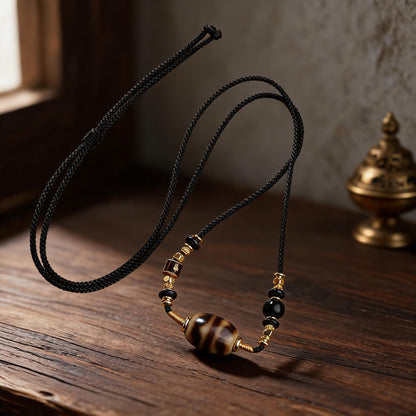 Handcrafted Three-Eye Dzi & Coconut Shell Necklace - Dzi surface macro