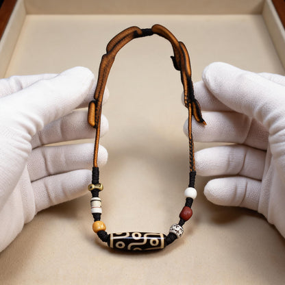 Handcrafted Horizontal Nine-Eye Dzi Necklace - white-glove scale