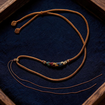 Hand painted Yellow Jambhala pendant close up