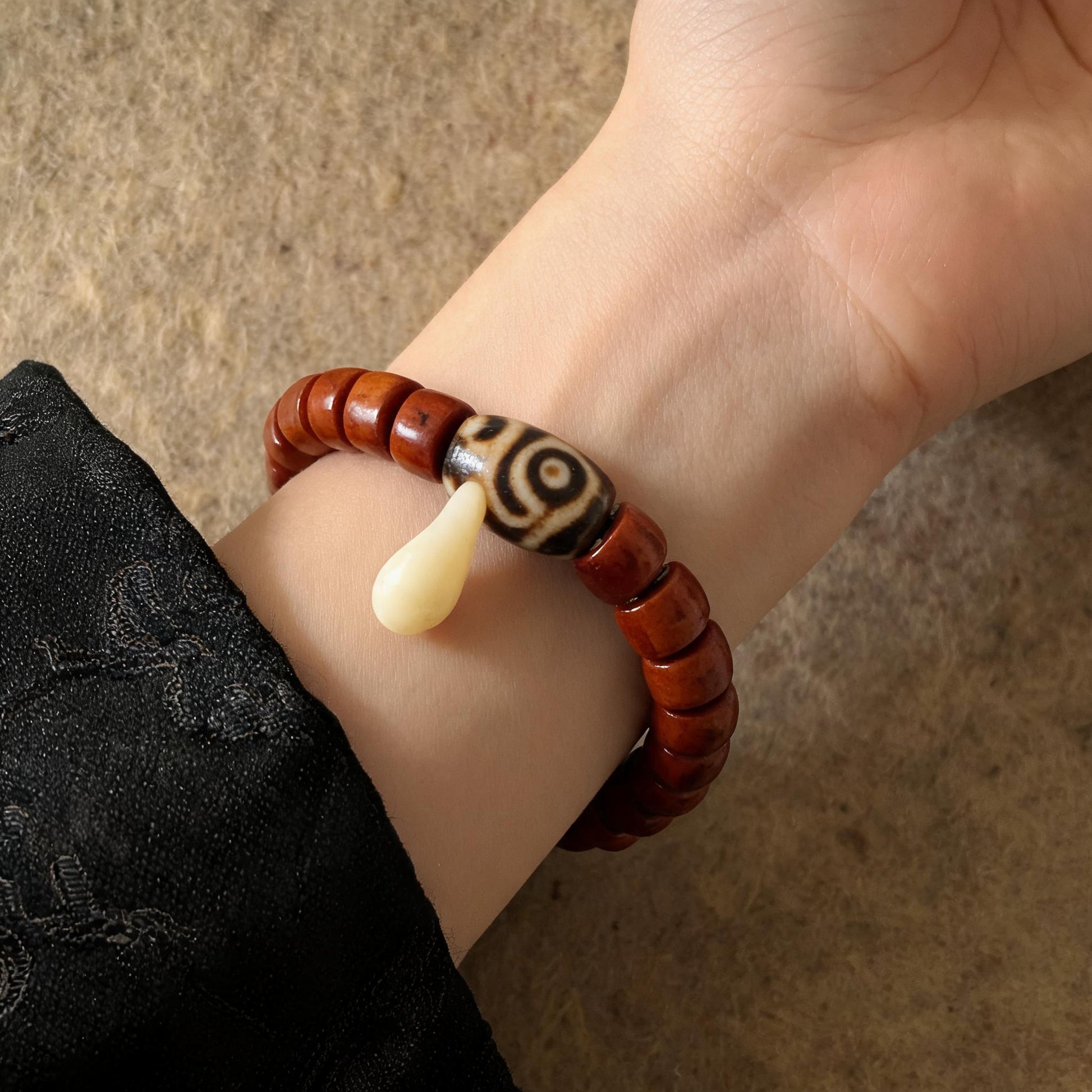 Dema Three-Eye Dzi and yak bone bracelet worn on wrist