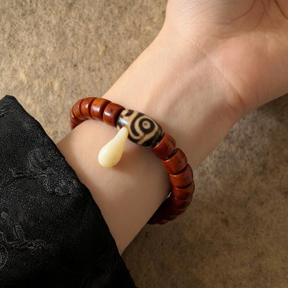 Dema Three-Eye Dzi and yak bone bracelet worn on wrist