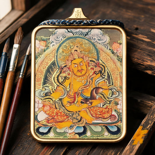 Yellow Jambhala Hand-Painted Thangka Pendant in an artisan workshop setting