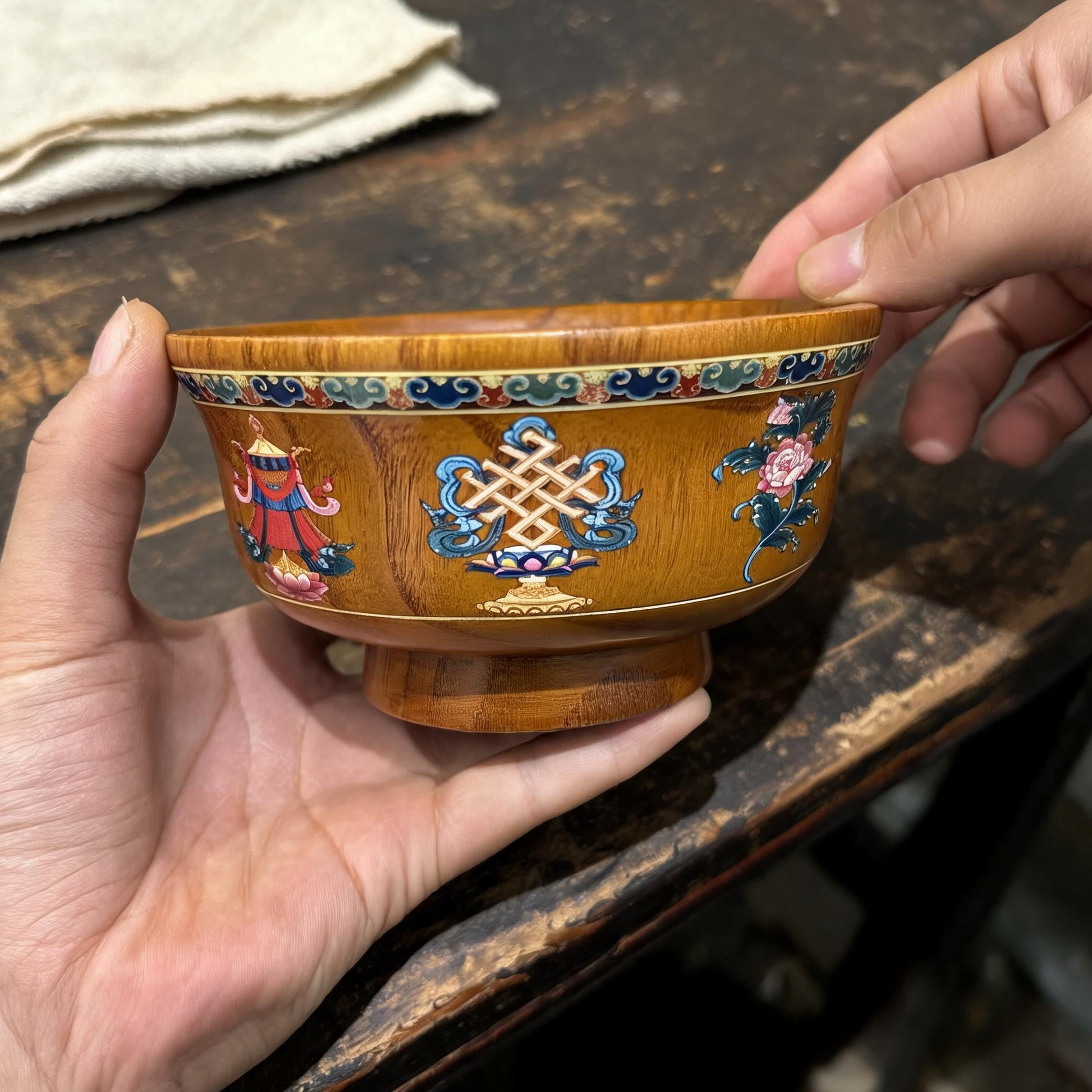 Eight Auspicious Motifs Hand-Painted Solid Wood Bowl in an artisan workshop setting